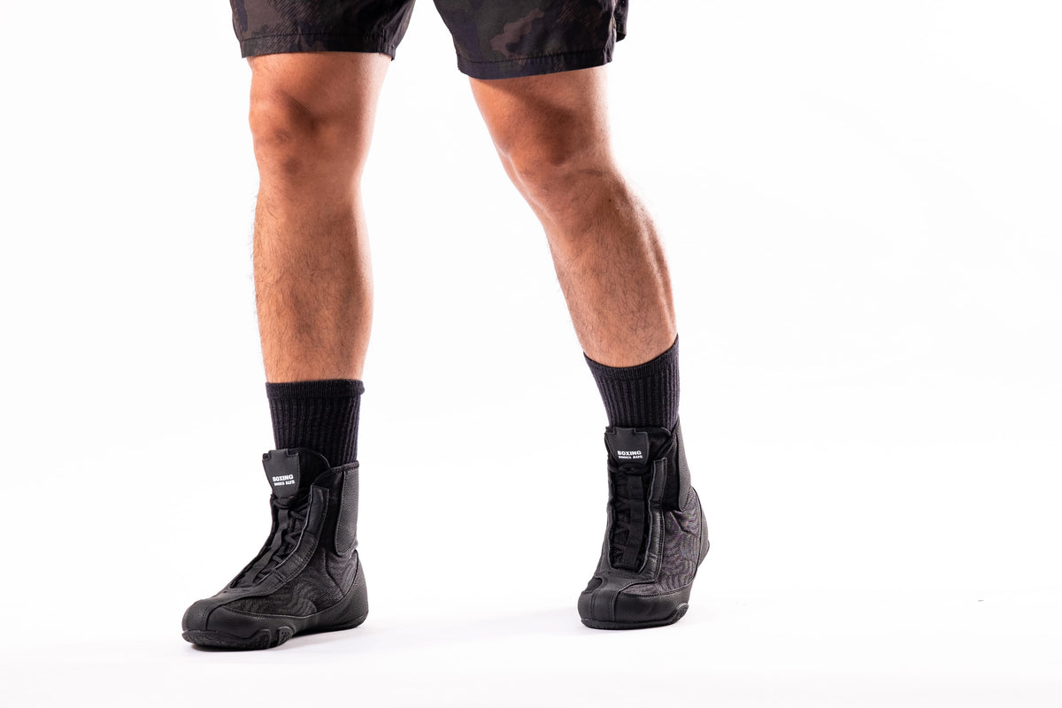 Boxer wearing boxing shoes during heavy bag training in a boxing gym
