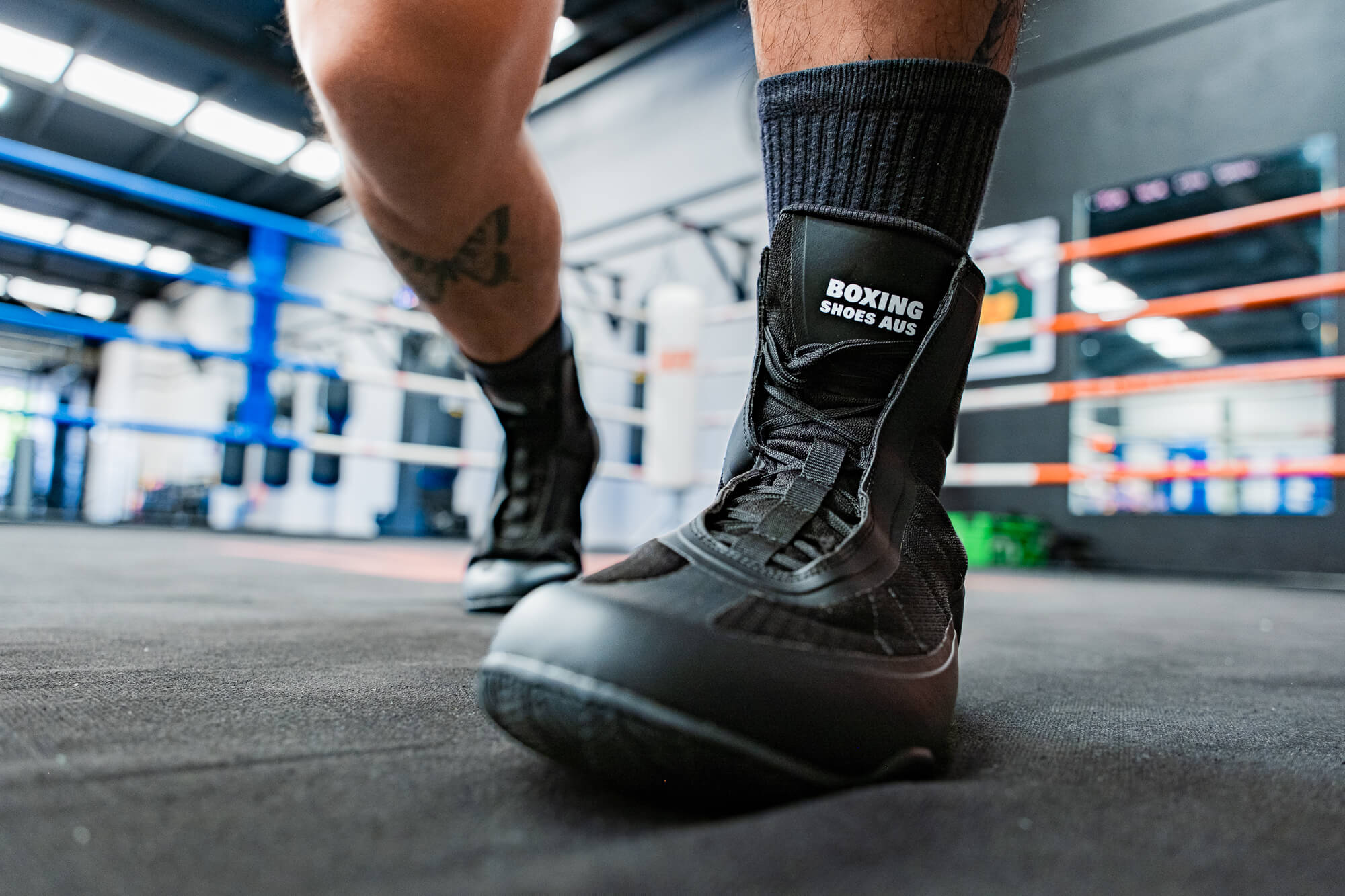 Black Boxing Shoes Aus boot on a mat, emphasising correct gym-only use and proper boxing shoe maintenance.